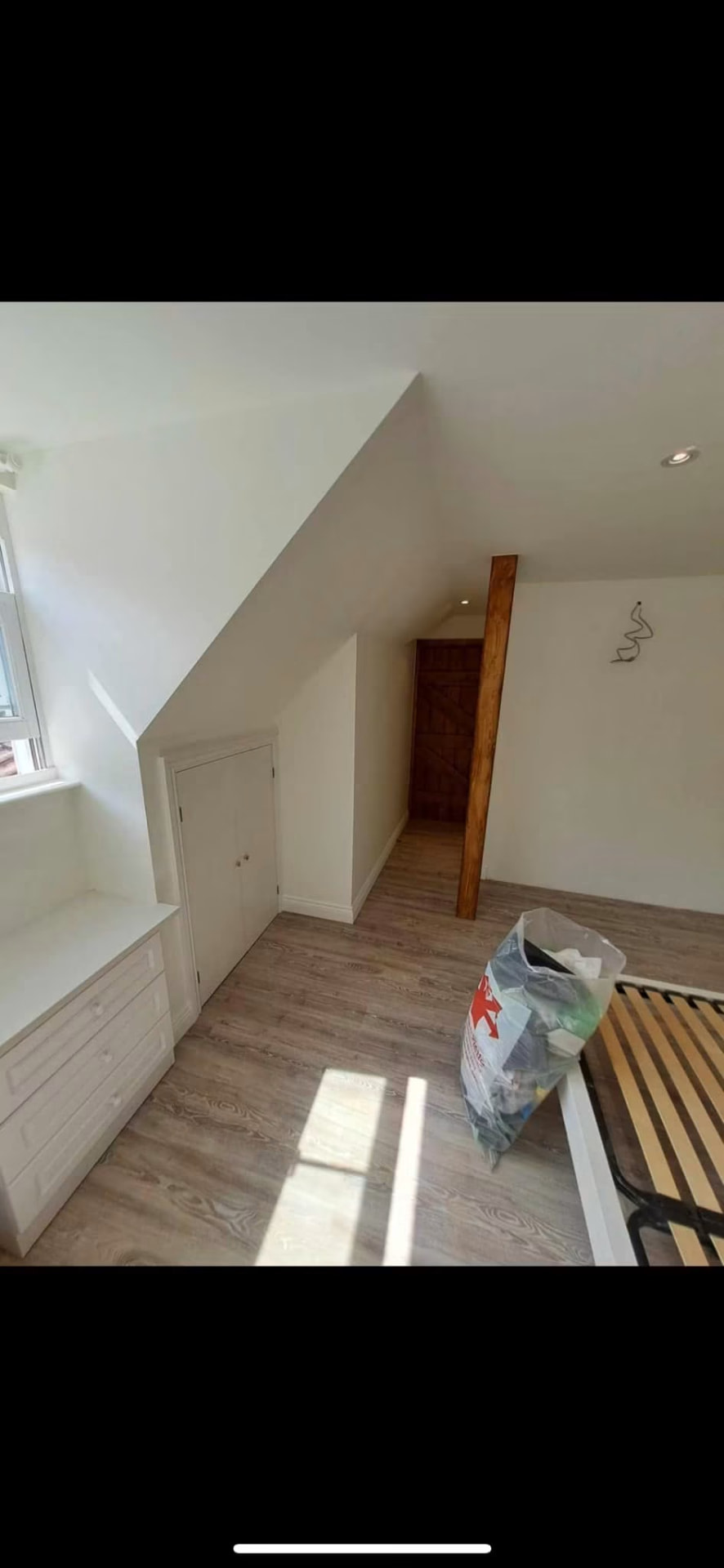 Finished master bedroom with bespoke fitted furniture and window seat storage