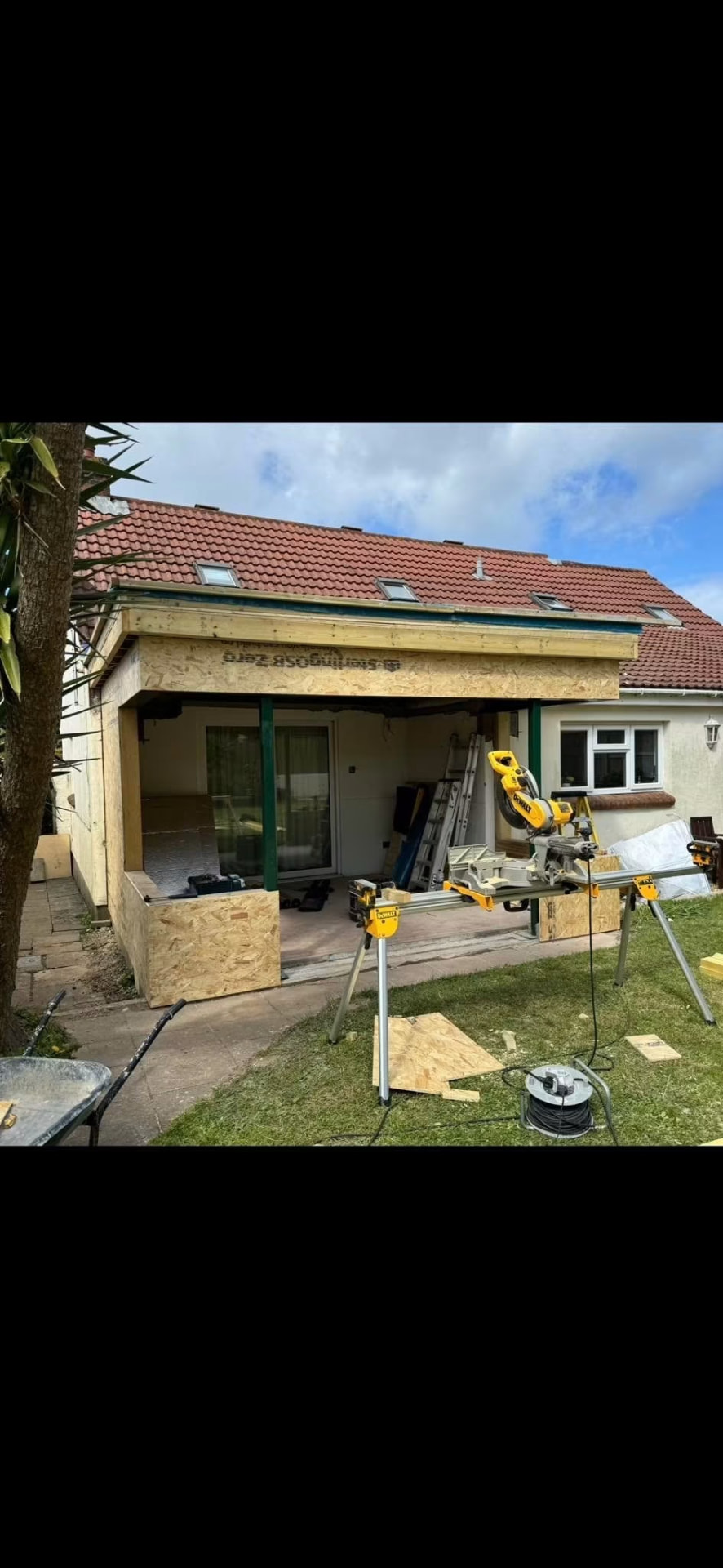 Before — OSB sheathing and flat roof structure taking shape