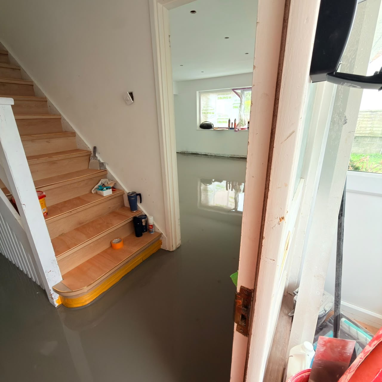 Before — Self-levelling compound poured over the heating system