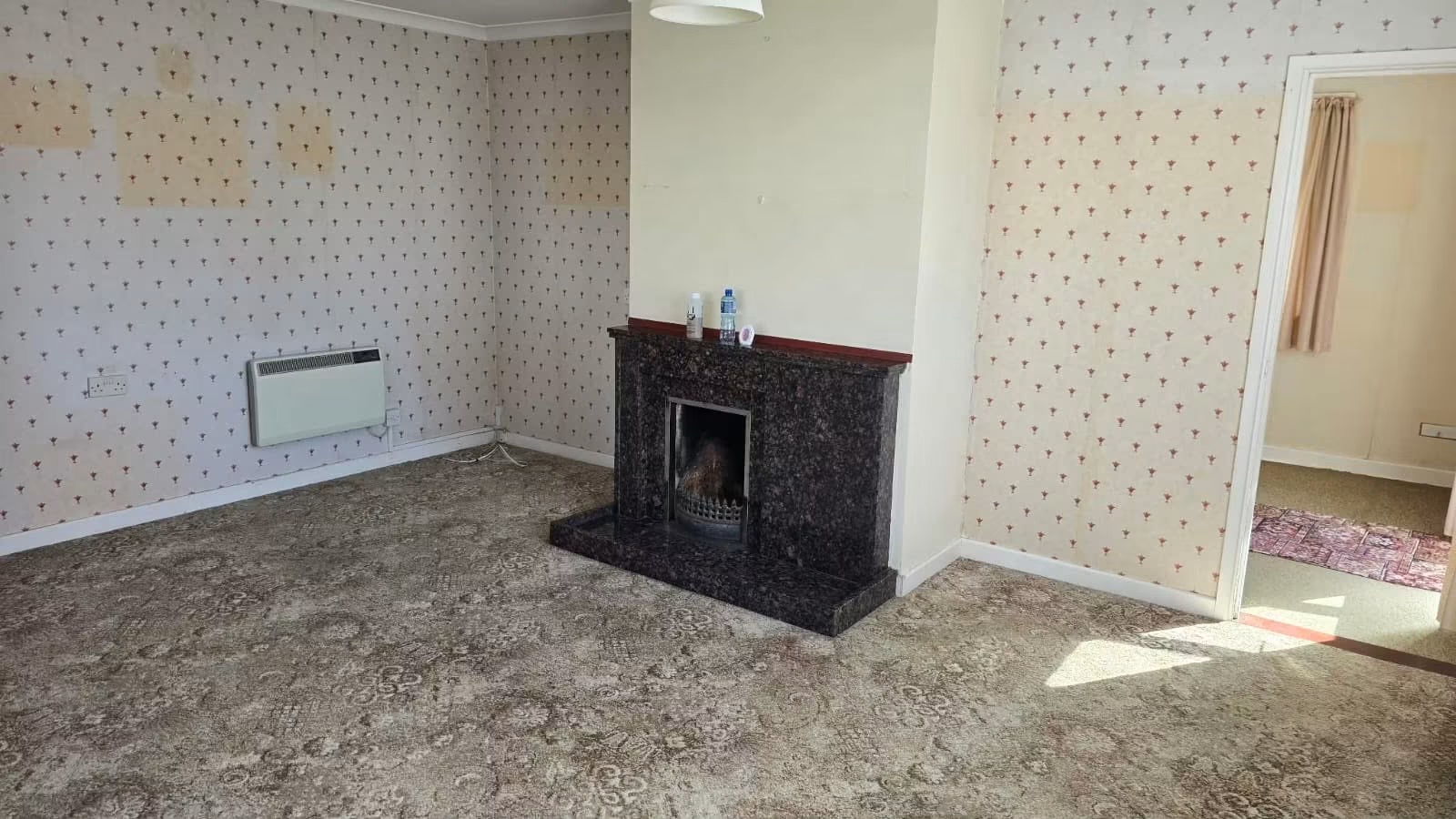 Dated lounge with original chimney breast before renovation, Guernsey