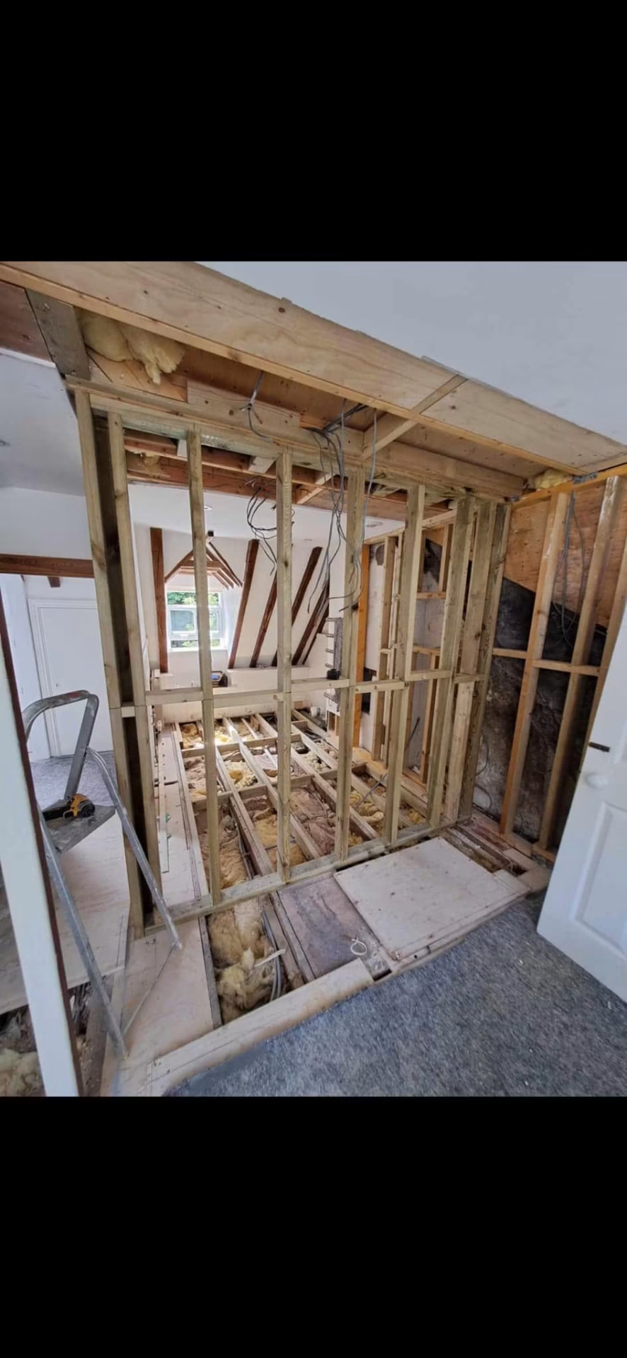 Partition framing and floor joists opened up for strengthening and new services