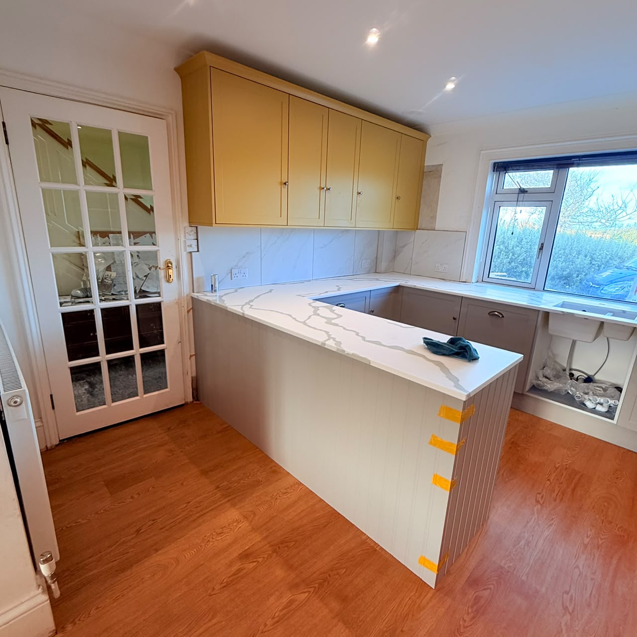 New peninsula with panelled detailing and quartz worktop