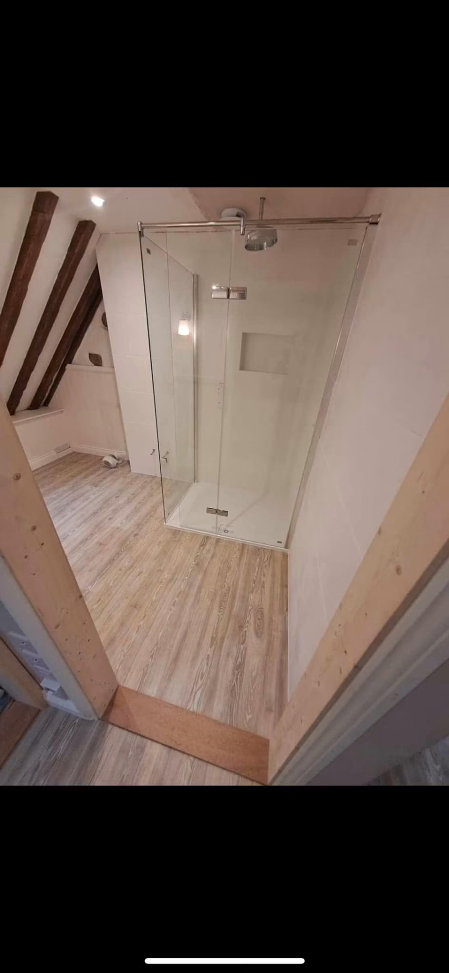 Completed walk-in shower with rainfall head and recessed tiled niche