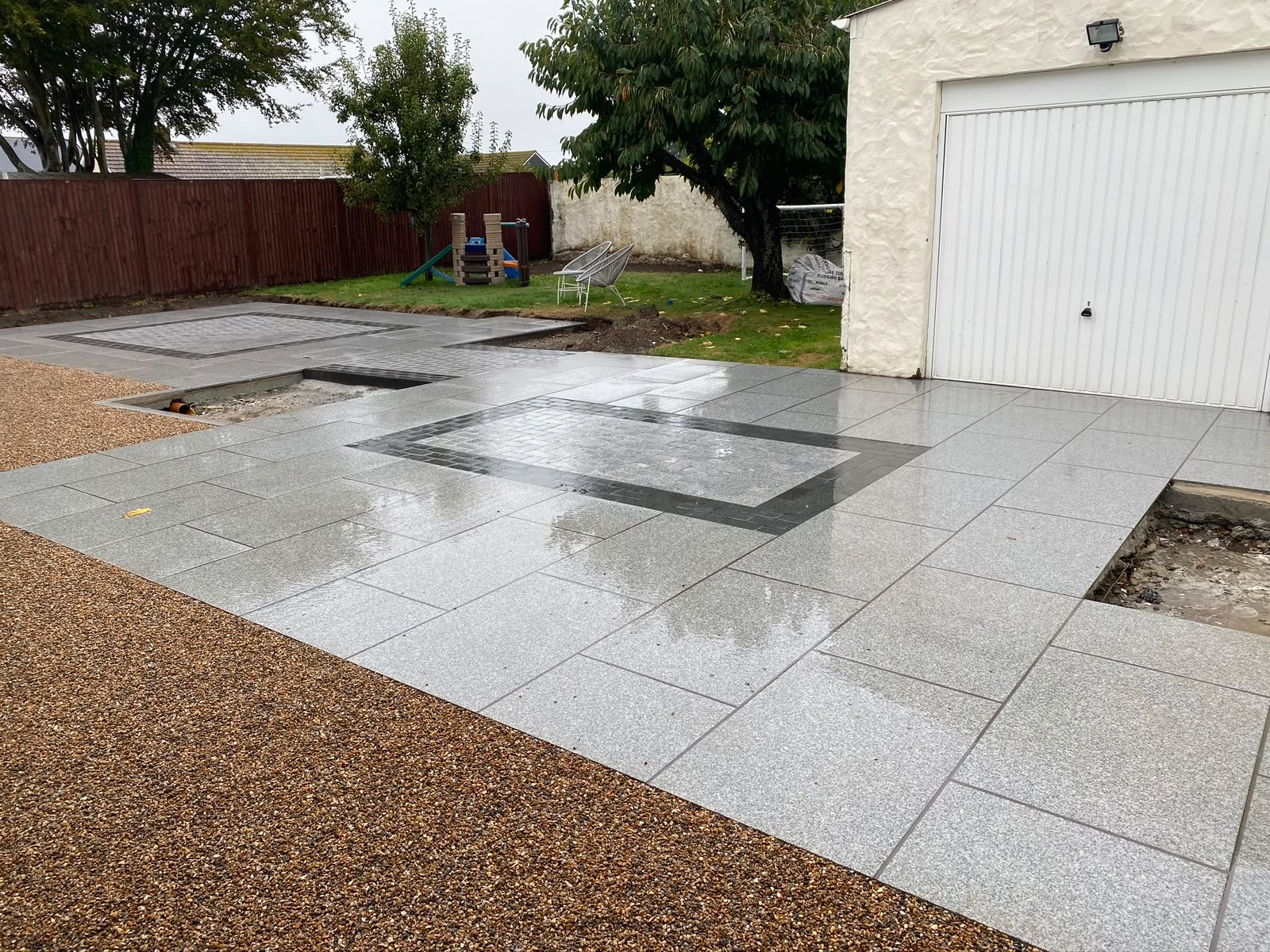 Crisp transition between granite paving and resin-bound margin