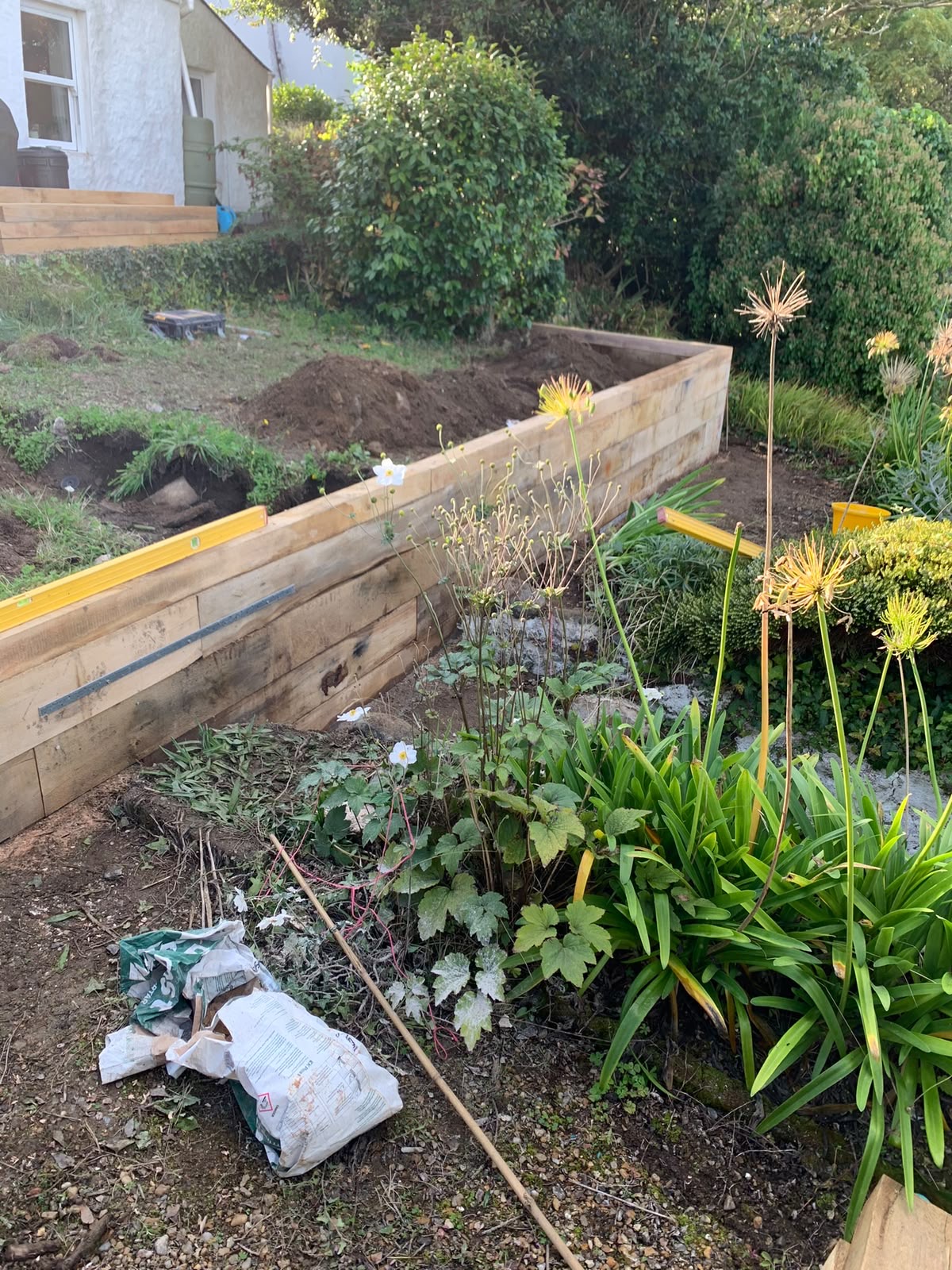 Sleeper planter walls being levelled during the build