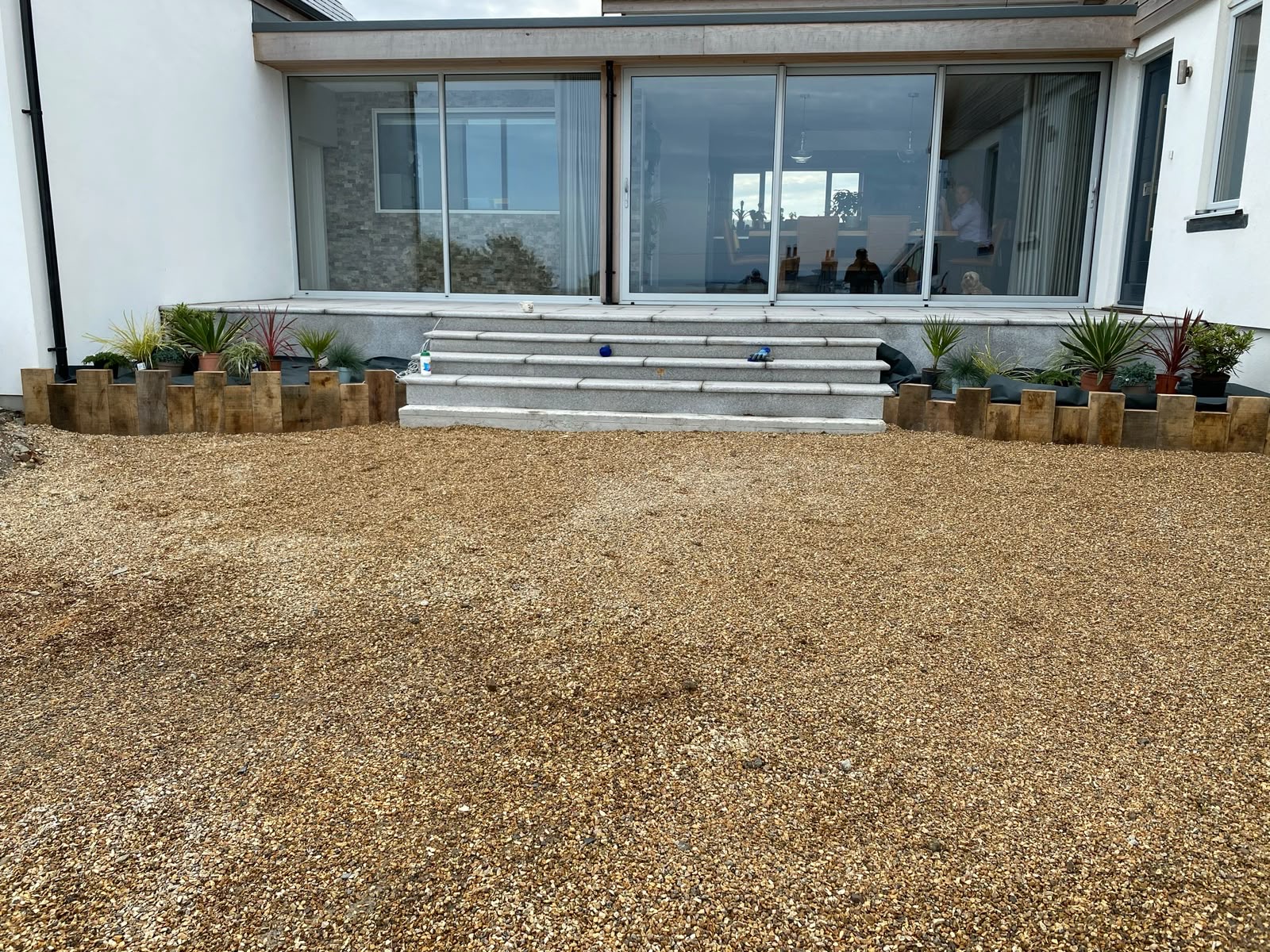 Granite steps, sleeper planters and decorative gravel finish