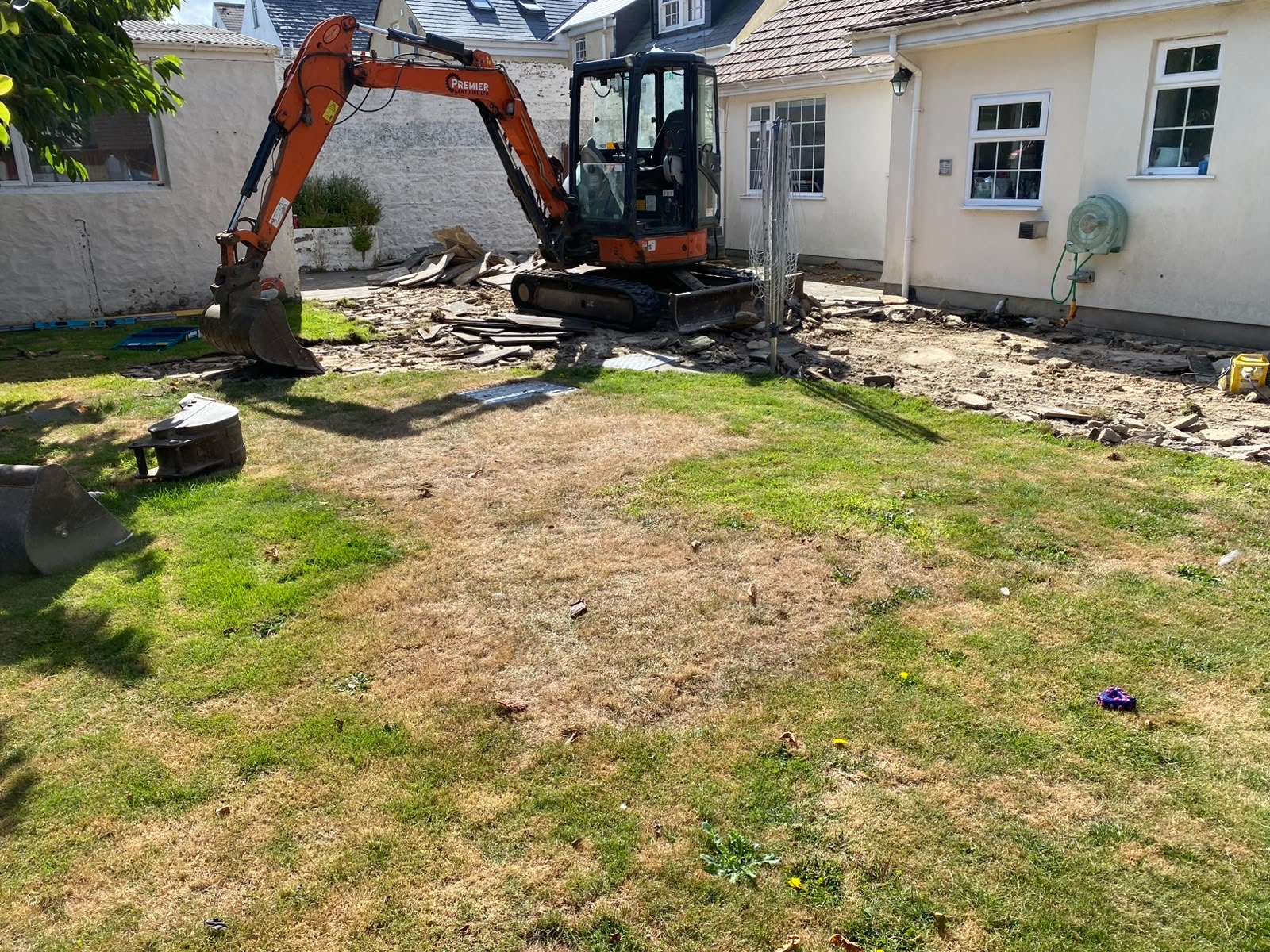Mini excavator reducing levels across the patio footprint