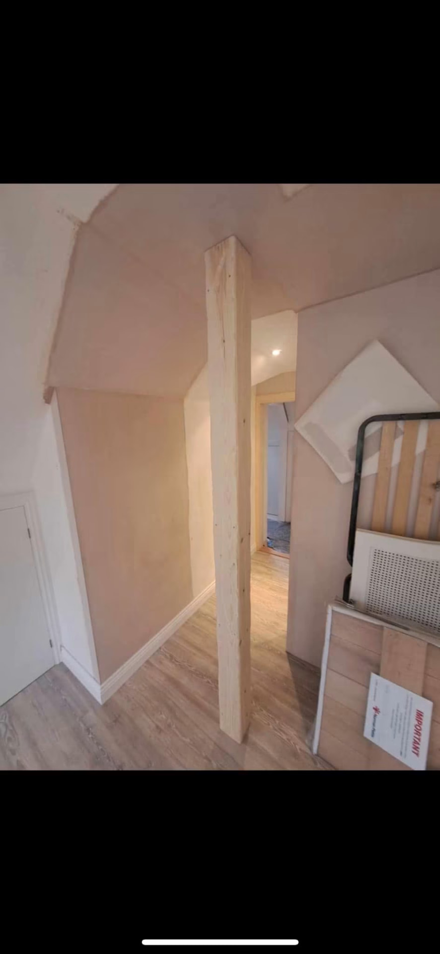Boxed structural post and freshly skimmed walls through to the landing