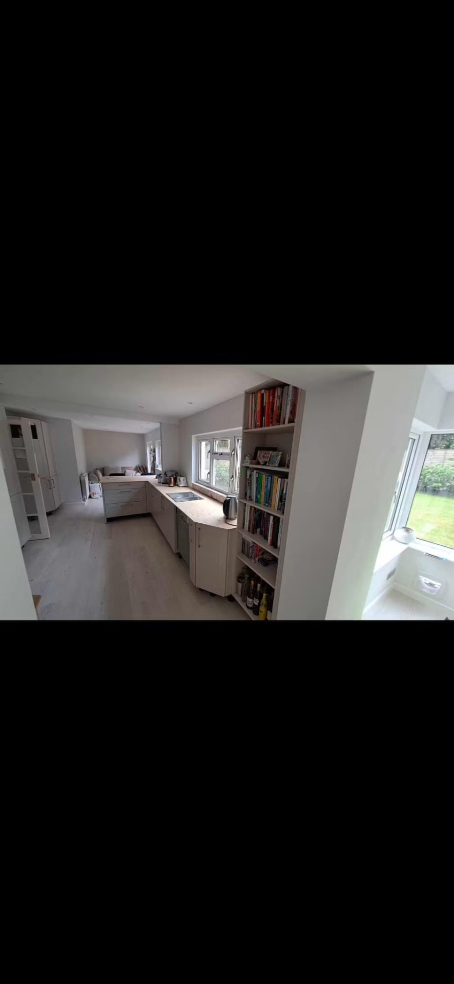 After — New kitchen installed with built-in shelving and garden views