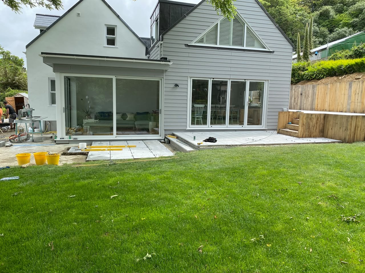 After — Rear elevation — level patio flowing off the living space