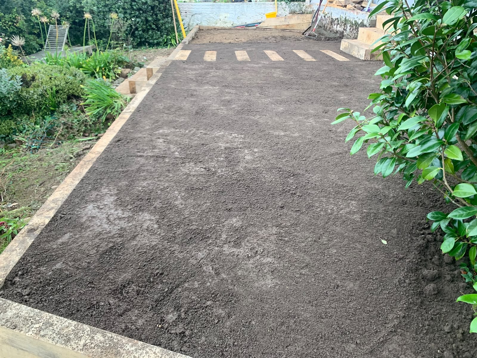 Terrace backfilled, graded and topsoiled ready for turf