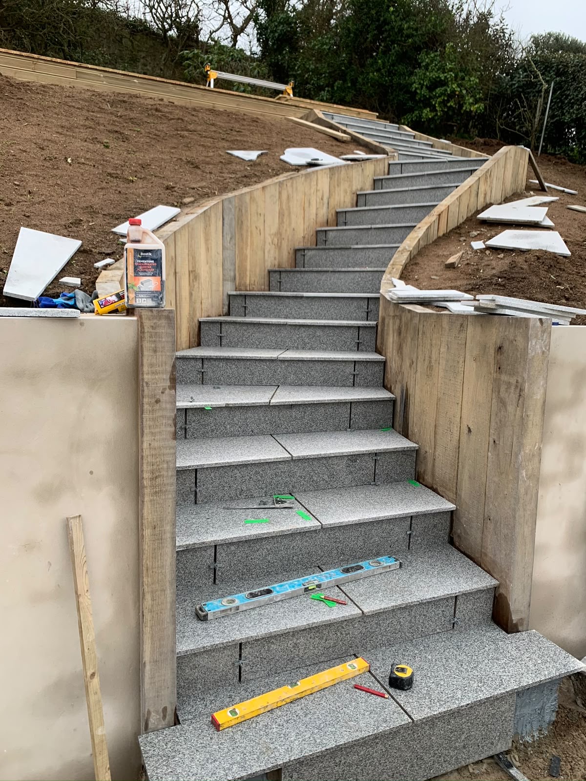 Granite treads being bedded and levelled on the curved staircase