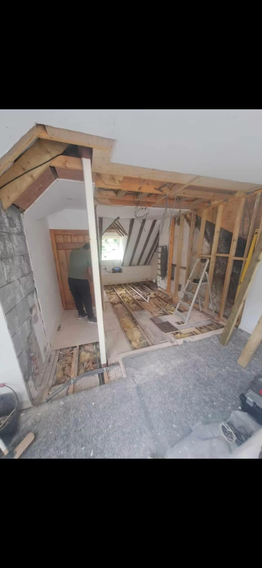 The suite stripped back to masonry and joists ahead of reconfiguration