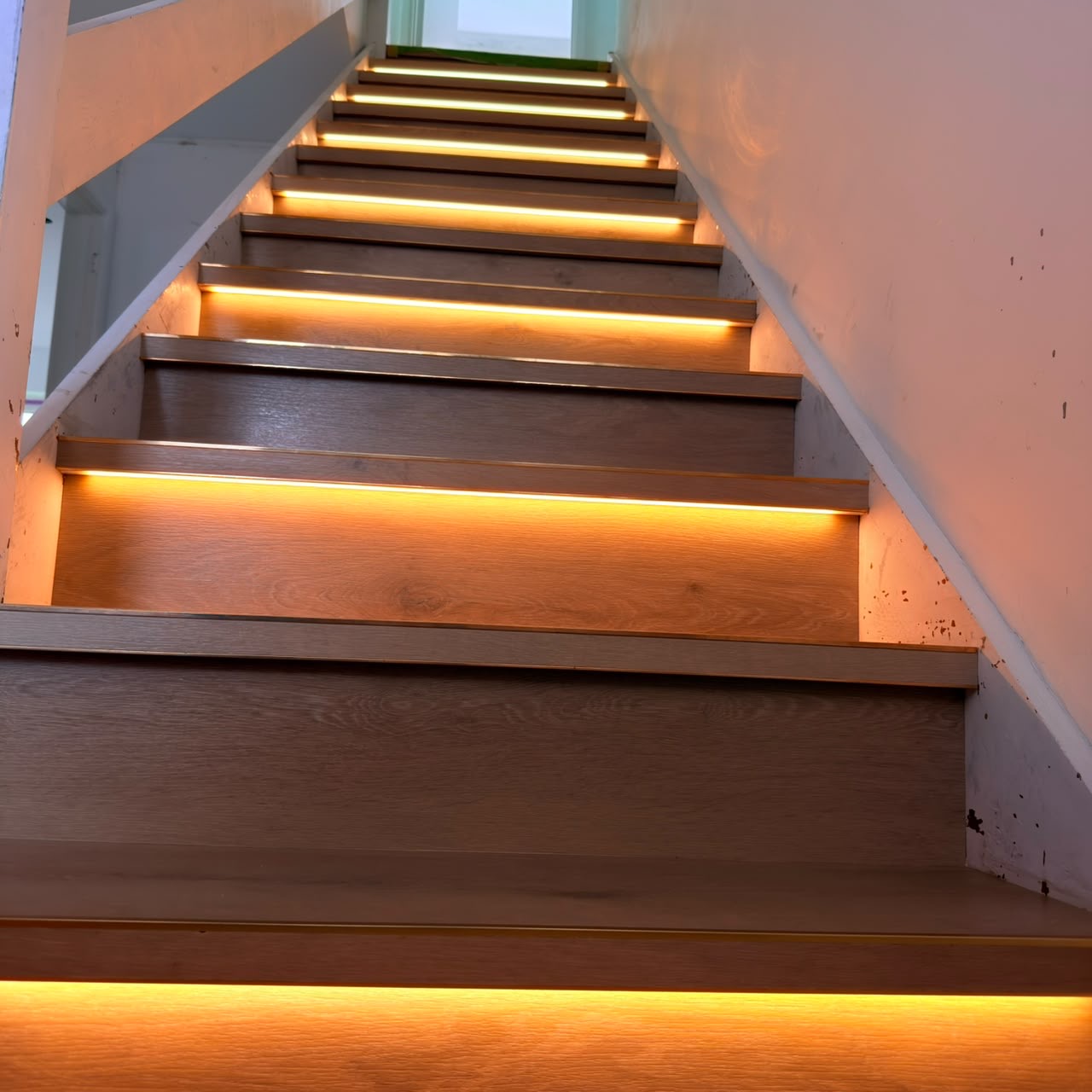 Renovated staircase with LVP treads and bespoke LED strip lighting, Guernsey