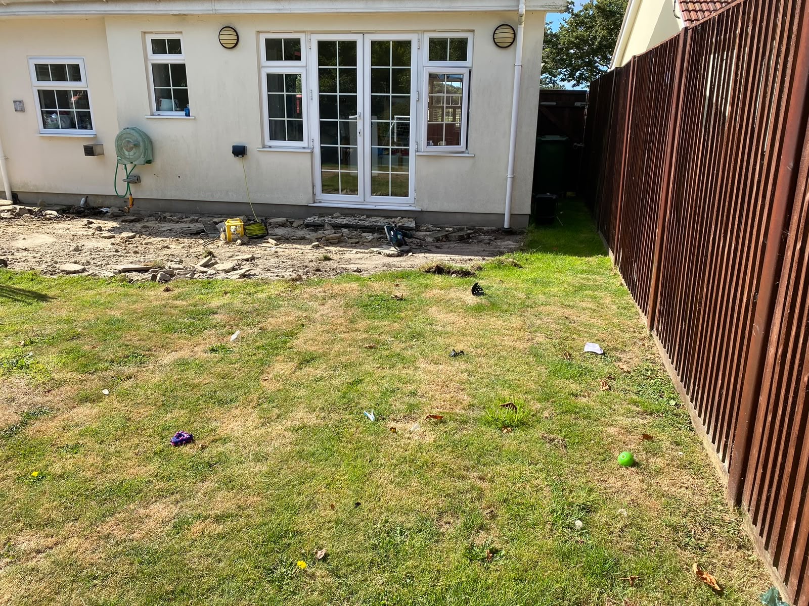 The original rear garden and tired hard standing before works began