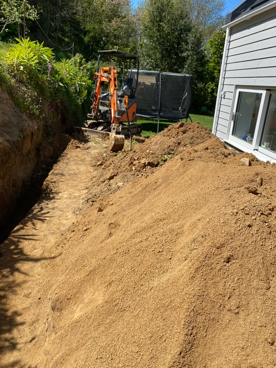 Excavation works cutting into the sloping garden bank, Guernsey